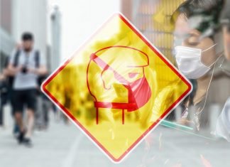Guerra al coronavirus Imagen artística de una señal con una persona que lleva mascarilla